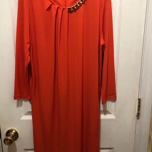A woman’s Michael Kors long sleeve silk dress